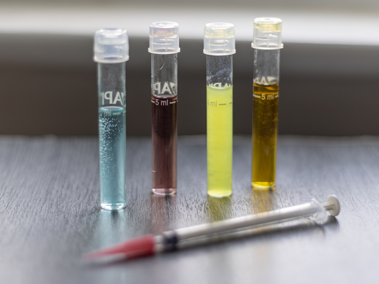 Laboratory test tubes with colorful chemical liquids for quality testing